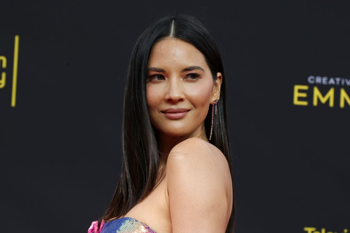 Olivia Munn with long hair glancing over her shoulder