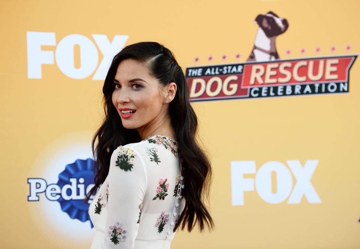 Olivia Munn looks over her shoulder at cameras