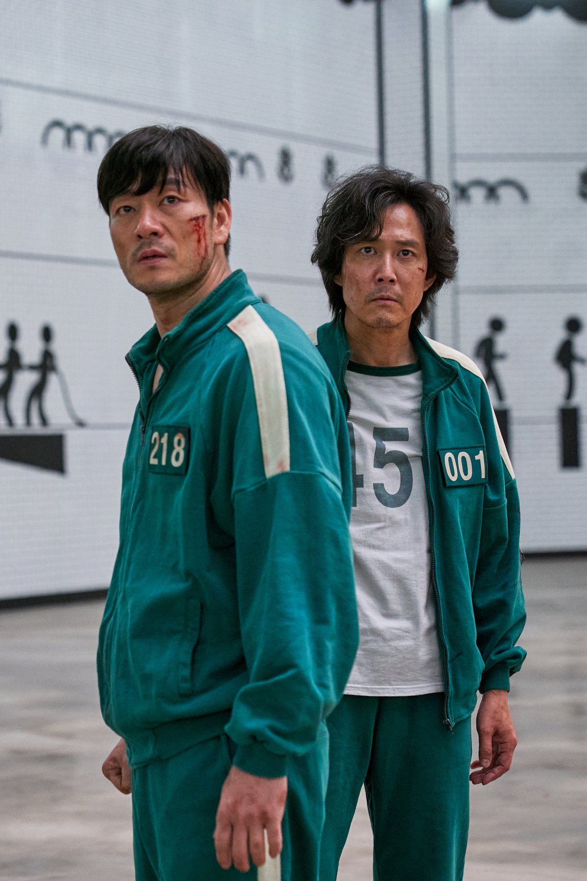 Park Hae-soo, and Lee Jung-jae wearing green jumpsuits as part of the 'Squid Game' cast.