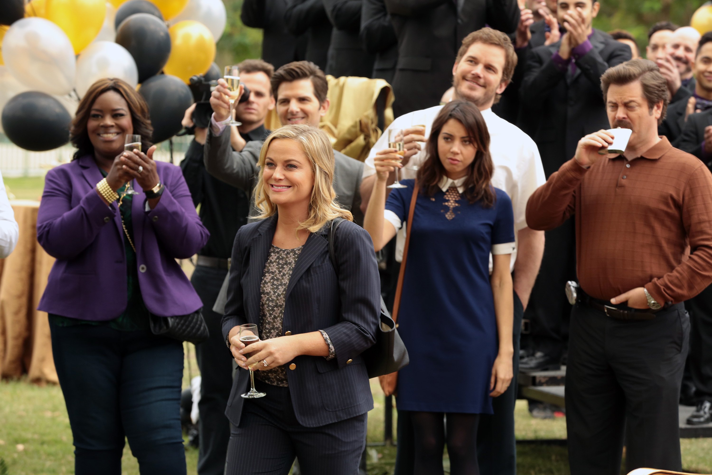 Parks and Recreation cast raises glasses in a toast
