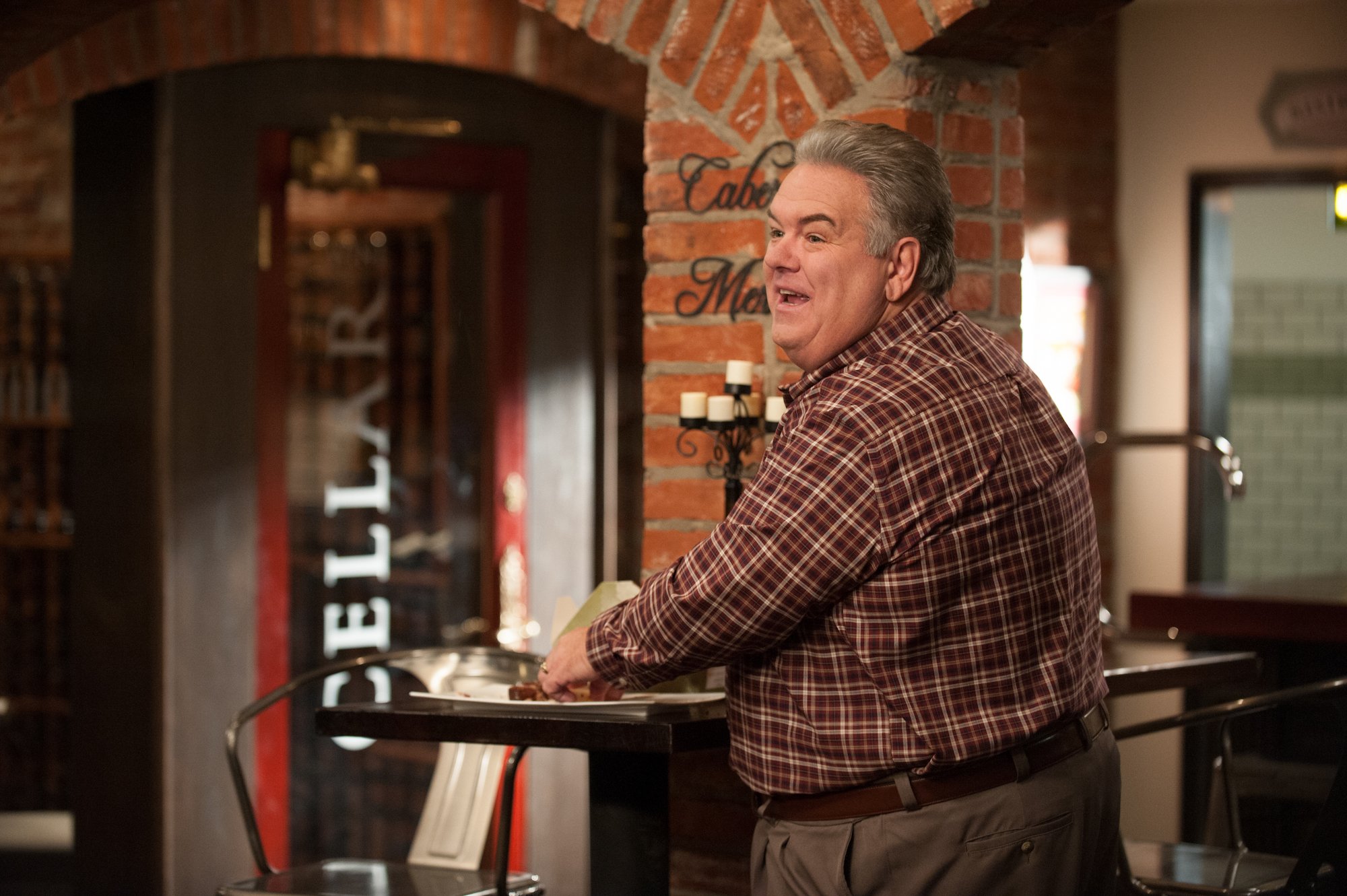 Parks and Recreation star Jim O'Heir stands at a restaurant counter
