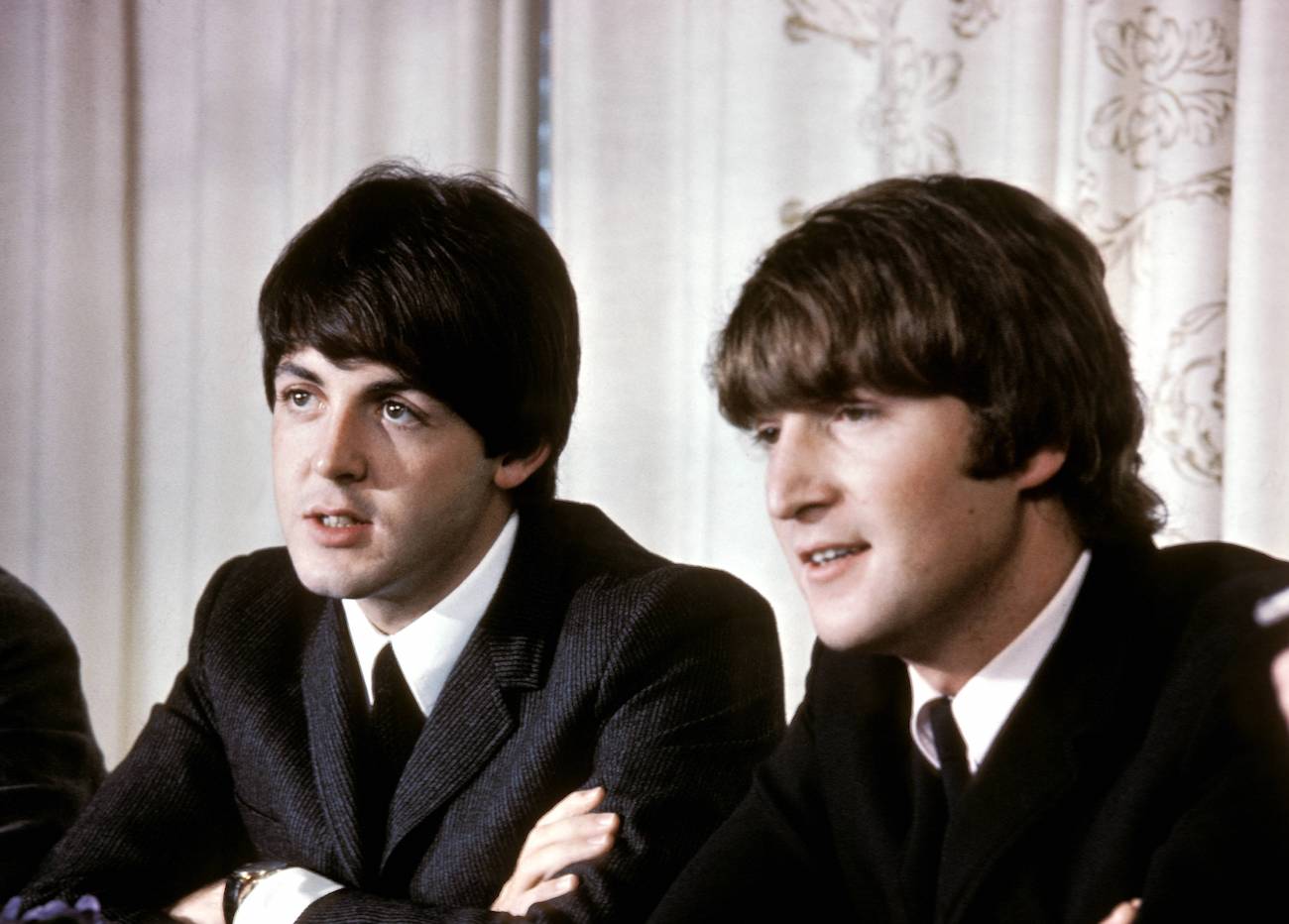 Paul McCartney and John Lennon at a press conference in Australia, 1964.