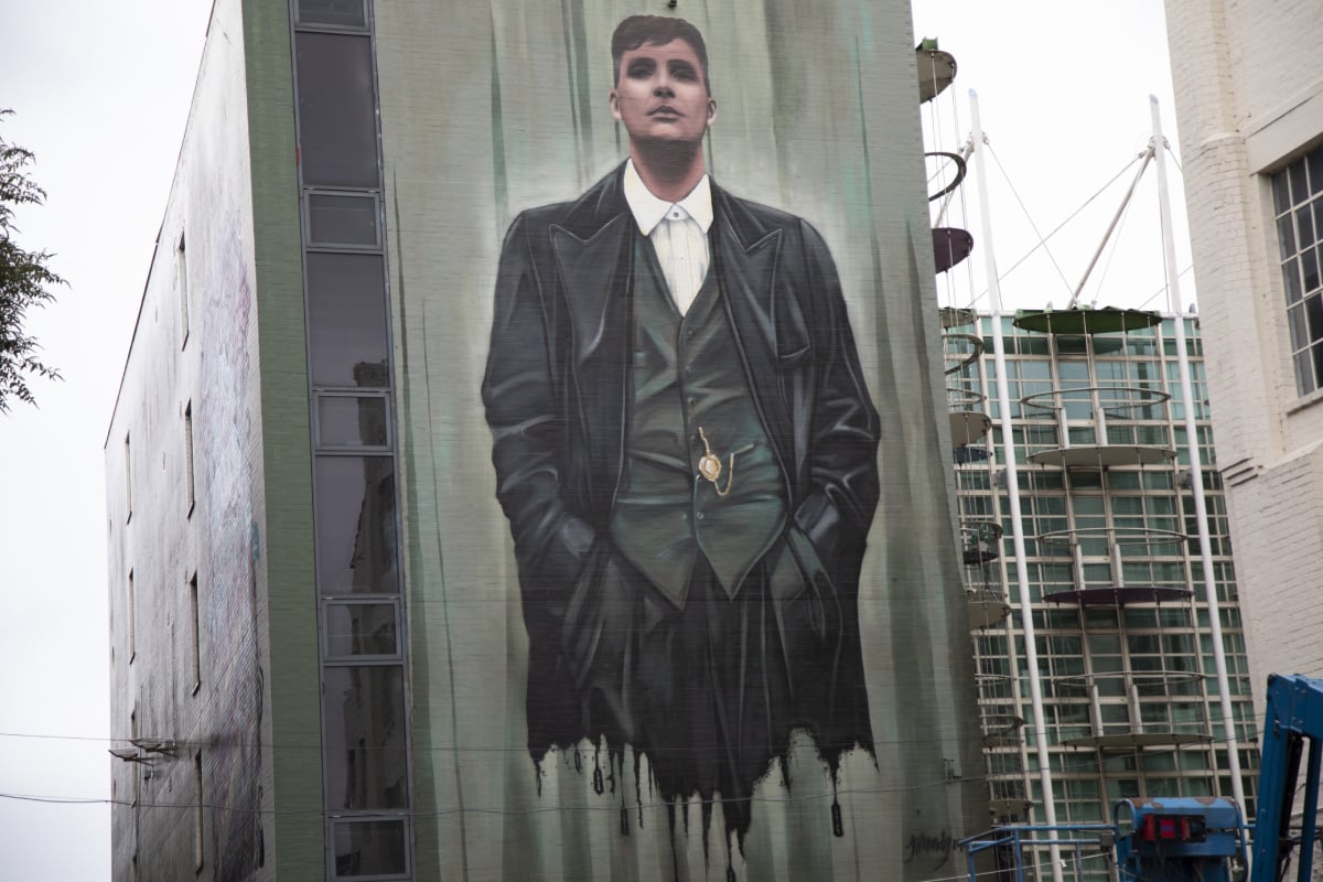 Peaky Blinders street art graffiti of Thomas Shelby wearing a suit in Digbeth, Birmingham.
