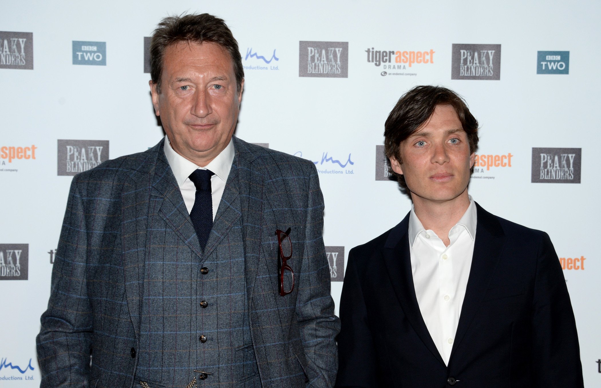 Steven Knight and Cillian Murphy from 'Peaky Blinders' Season 6 stand side-by-side at a premiere