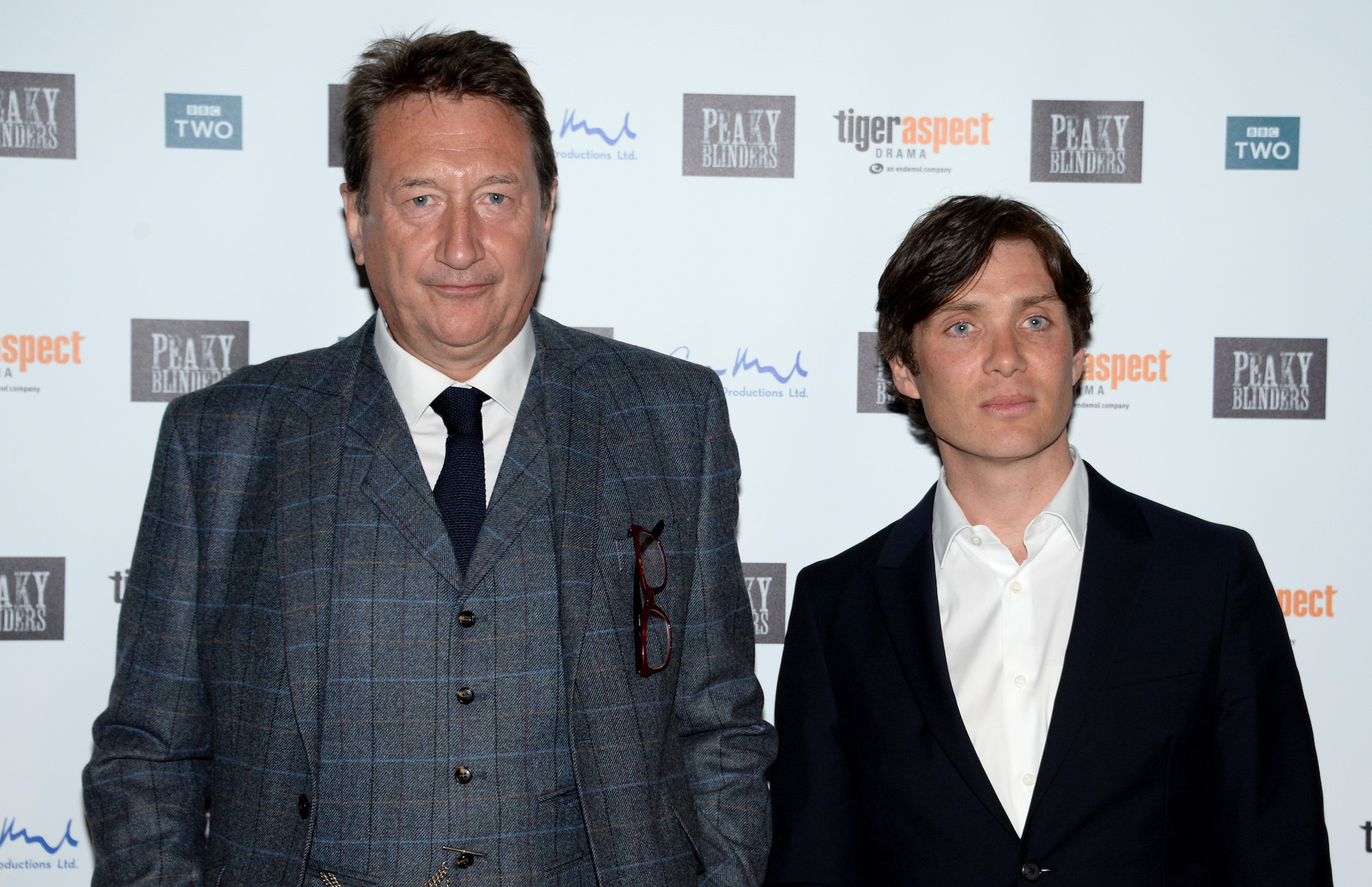 Steven Knight and Cillian Murphy from 'Peaky Blinders' Season 6 stand side-by-side at a premiere