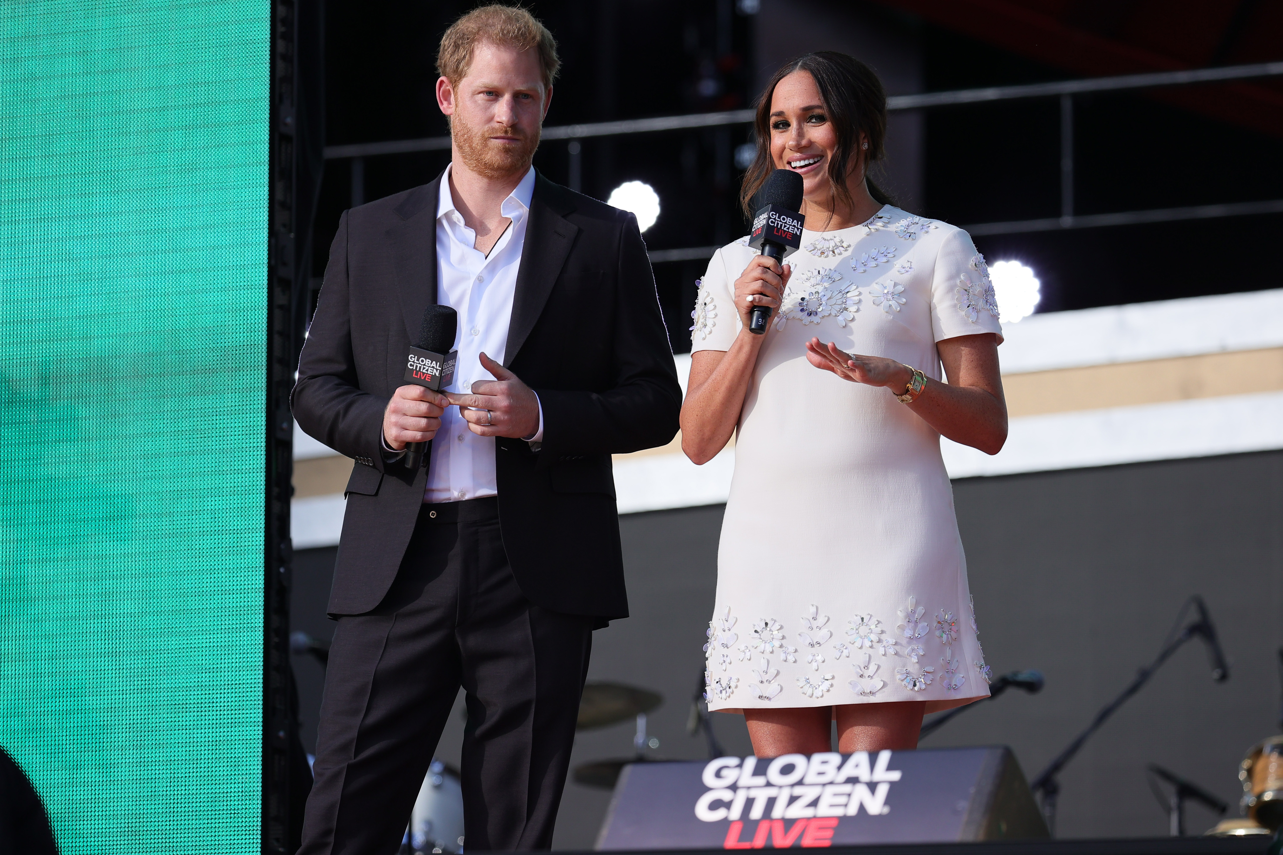 Prince Harry and Meghan Markle speaking onstage during Global Citizen Live