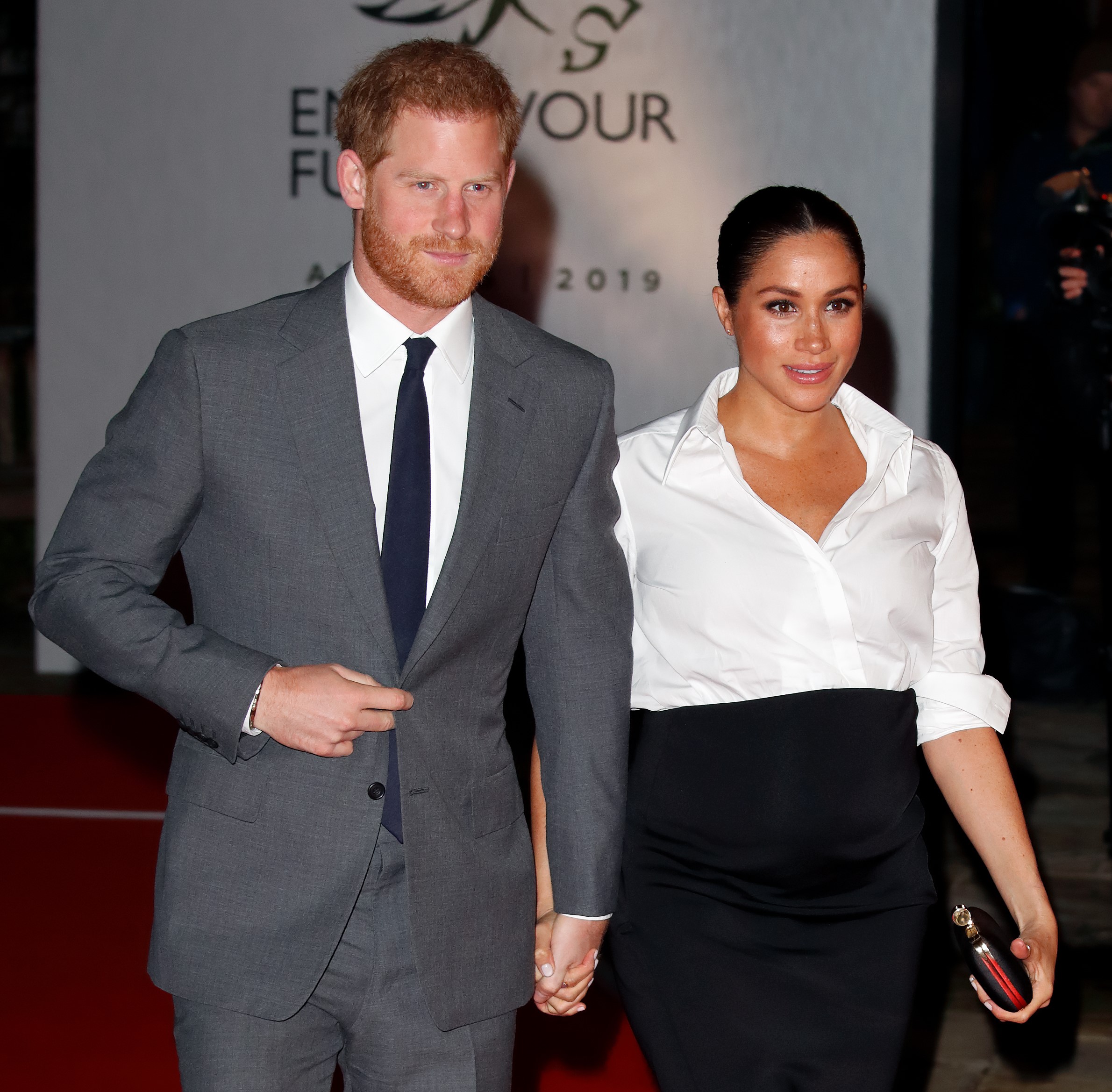 Prince Harry and Meghan Markle walking hand-in-hand at the Endeavour Fund Awards