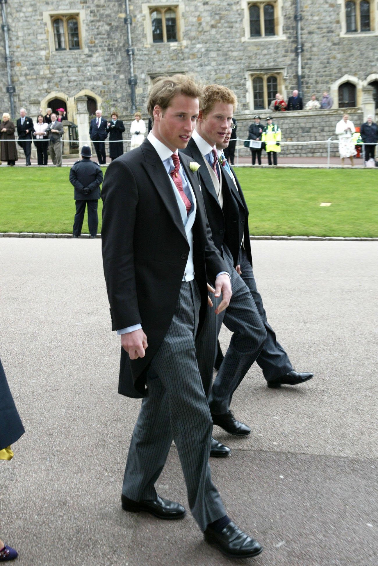 Prince Harry and Prince William walk side by side and look on