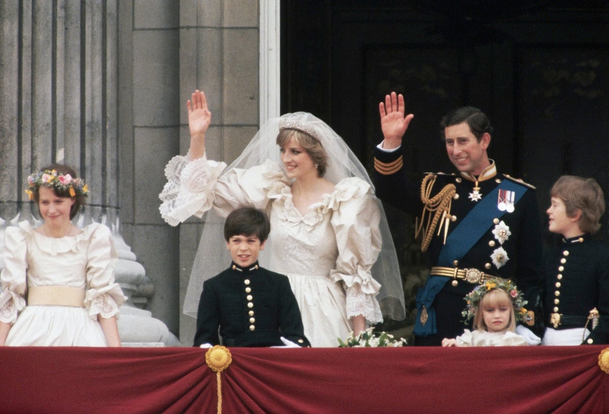 Princess Diana and Prince Charles standing on Buckingham Palace balcony with young members of the bridal party
