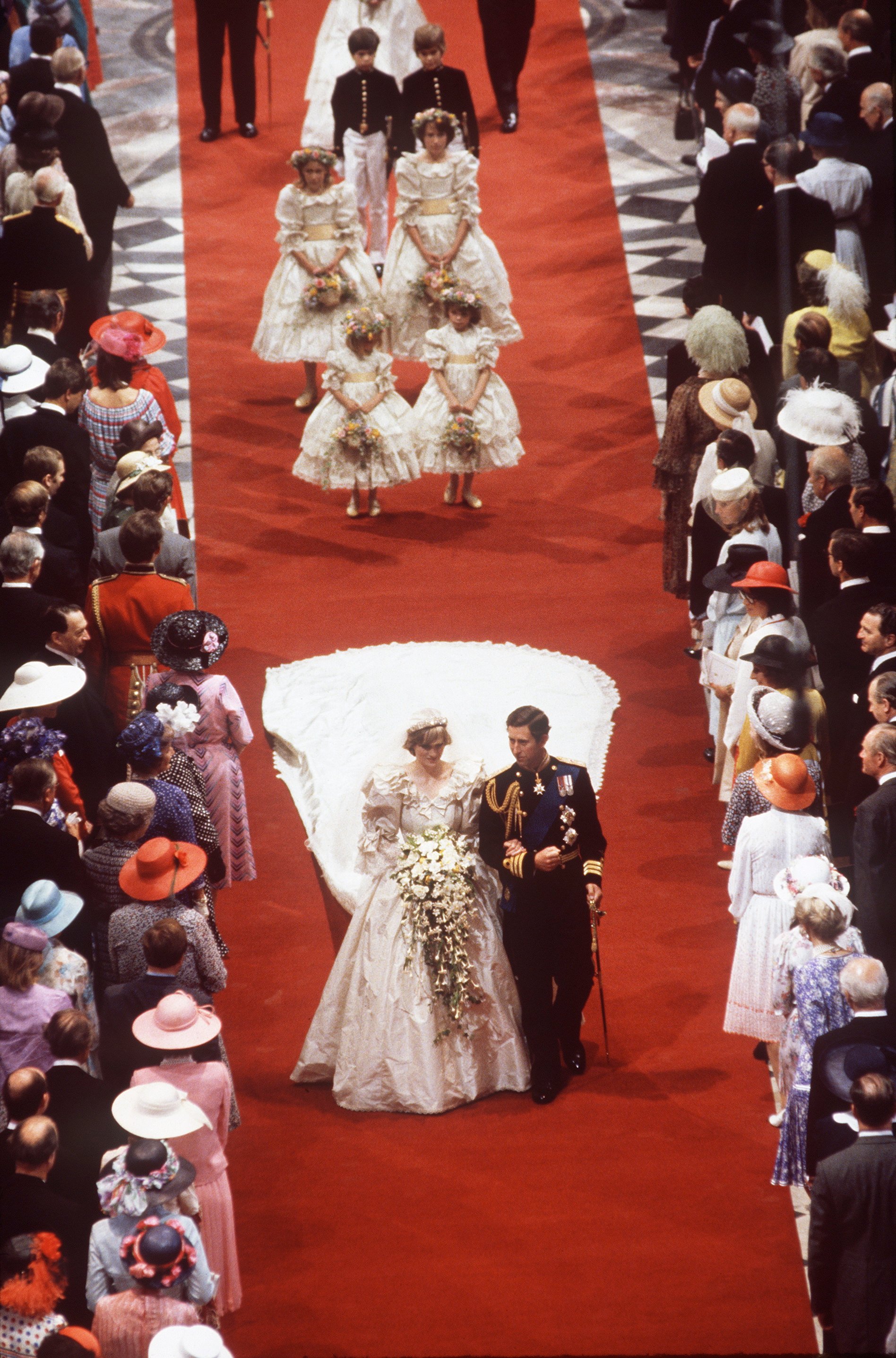 Princess Diana and Prince Charles walking down the aisle of St. Paul's on their wedding day followed by their bridesmaids and pageboys