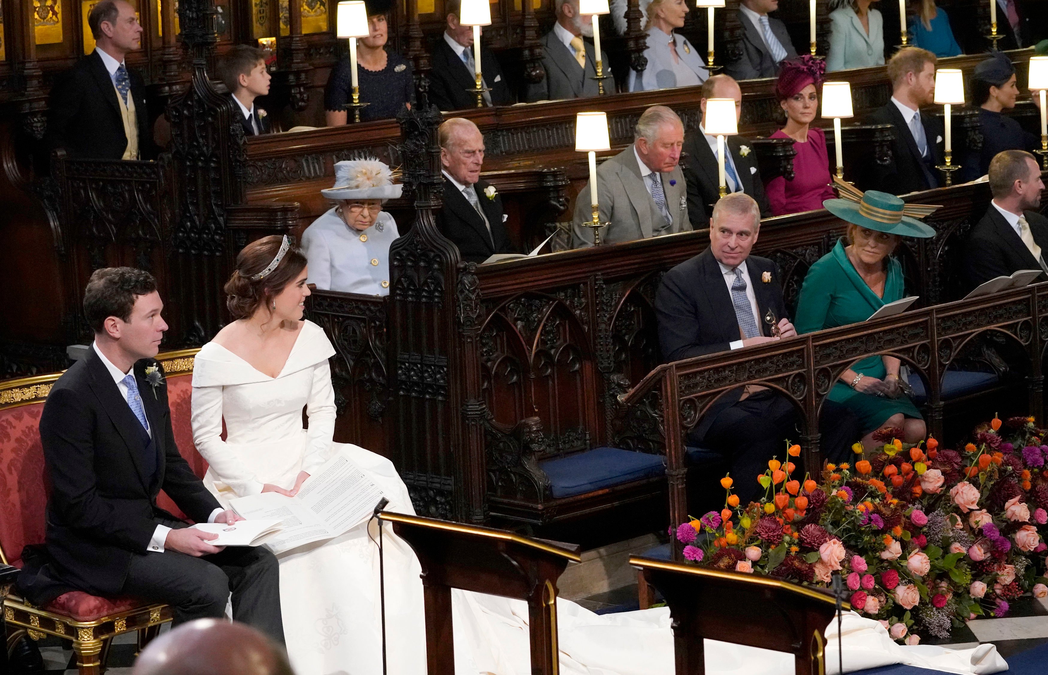 Princess Eugenie and Jack Brooksbank look towards Prince Andrew and Sarah Ferguson during wedding ceremony