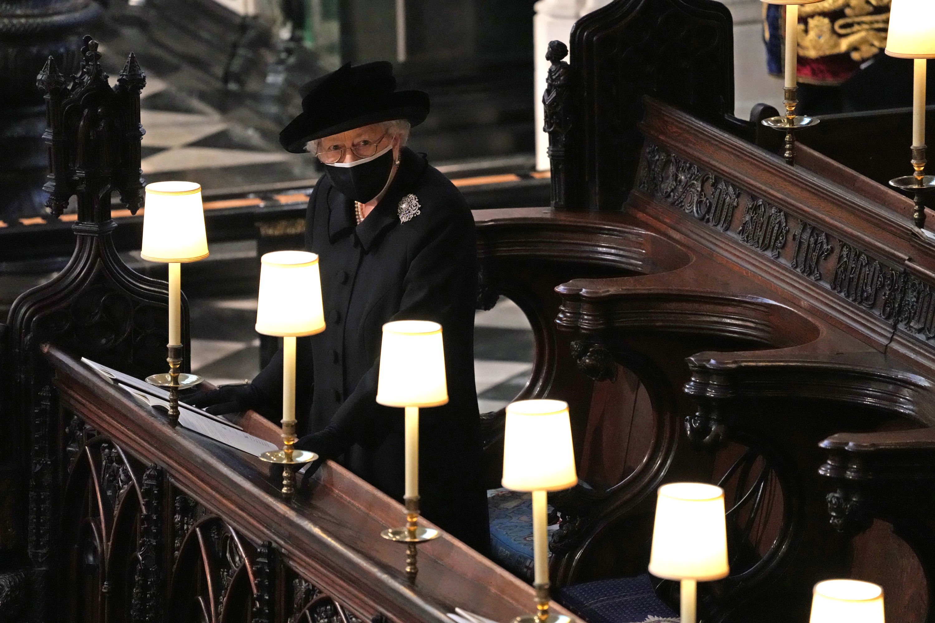 Queen Elizabeth II watches as pallbearers carry the coffin of Prince Philip