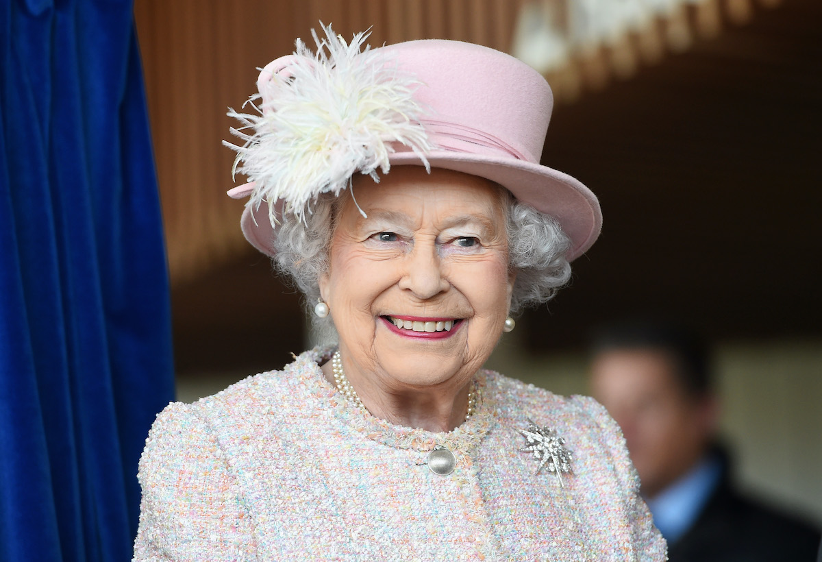 Queen Elizabeth II in a light pink hat and top