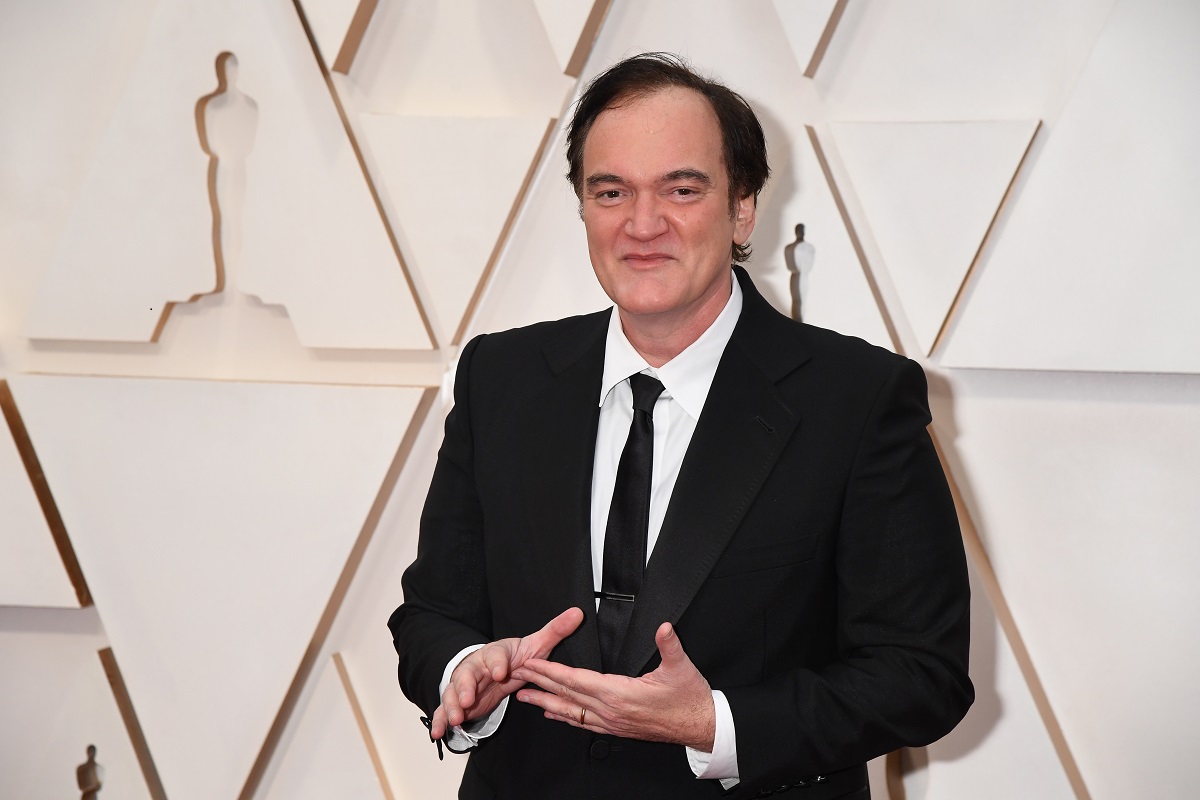 Quentin Tarantino smirking in a suit