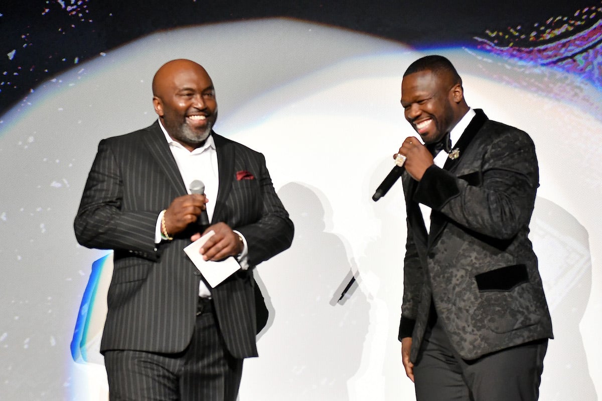Randy Huggins and 50 Cent speak onstage during the BMF world premiere screening wearing black suits