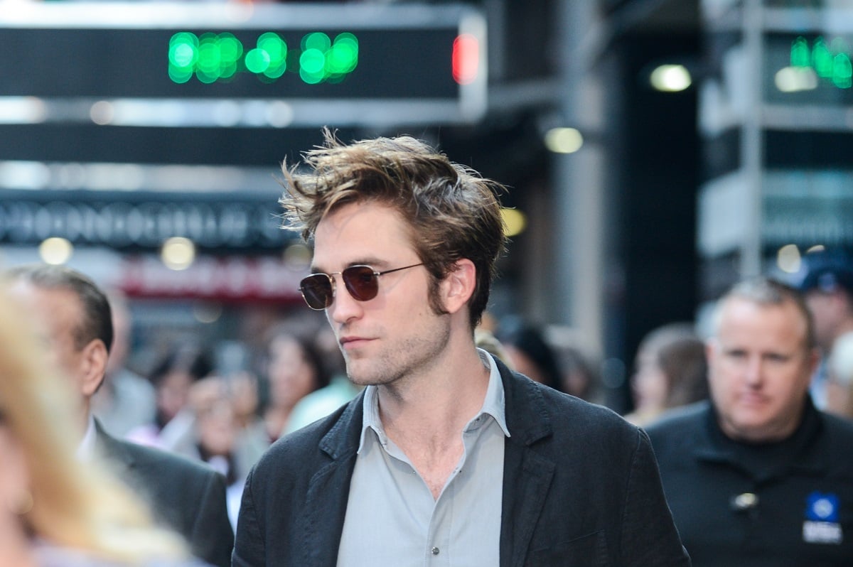 Robert Pattinson wearing sunglasses and a suit