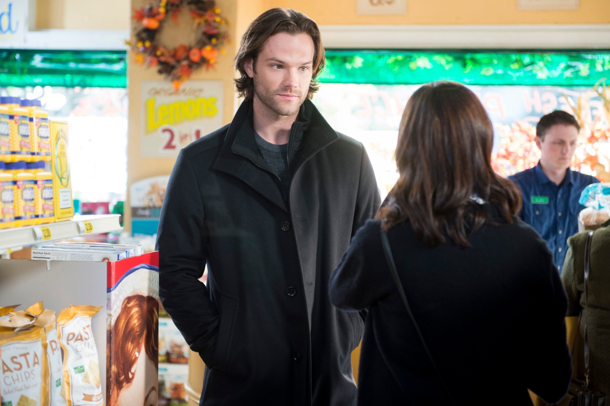 Jared Padalecki and Alexis Bledel as Dean and Rory in 'Gilmore Girls: A Year in the Life' on Netflix. Dean is wearing a black coat and looks uncomfortable. Rory is facing him but away from the camera.