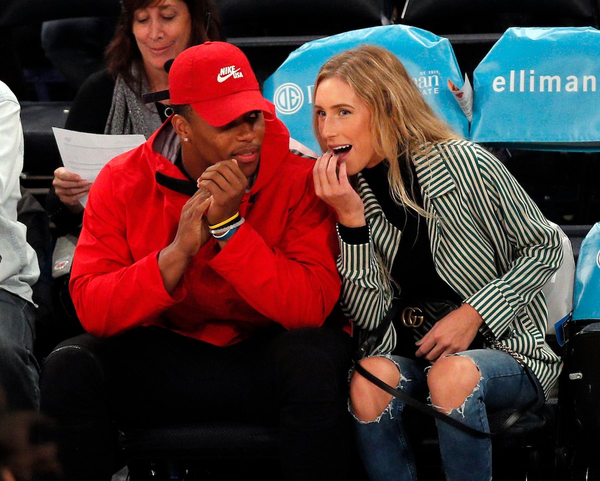 Running back Saquon Barkley of the New York Giants sits with partner Anna Congdon as they attend an NBA game