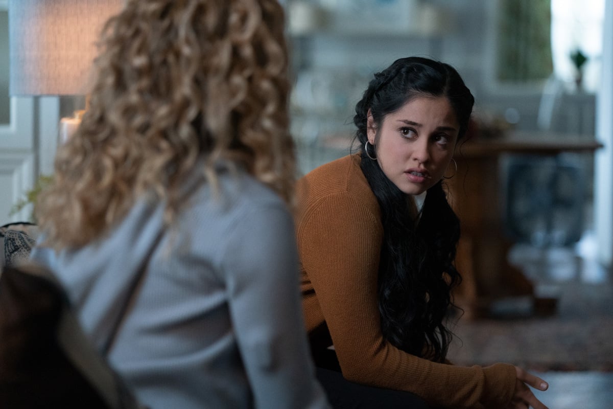 'Stargirl' Season 2 actor Yvette Monreal, in character as Yolanda Montez, wears a light brown sweater and her hair in braids.