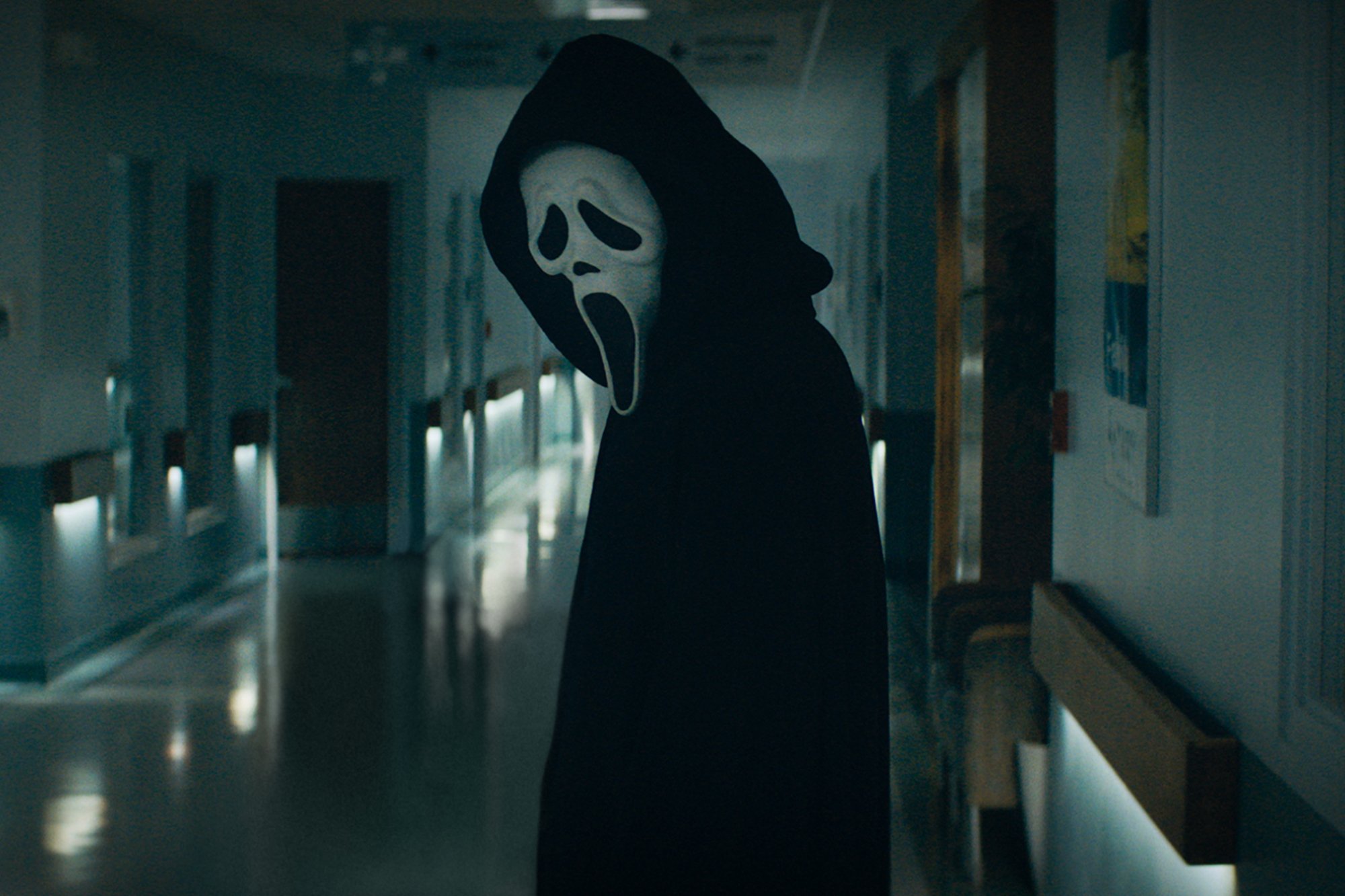 'Scream 5' killer Ghostface standing in a hallway