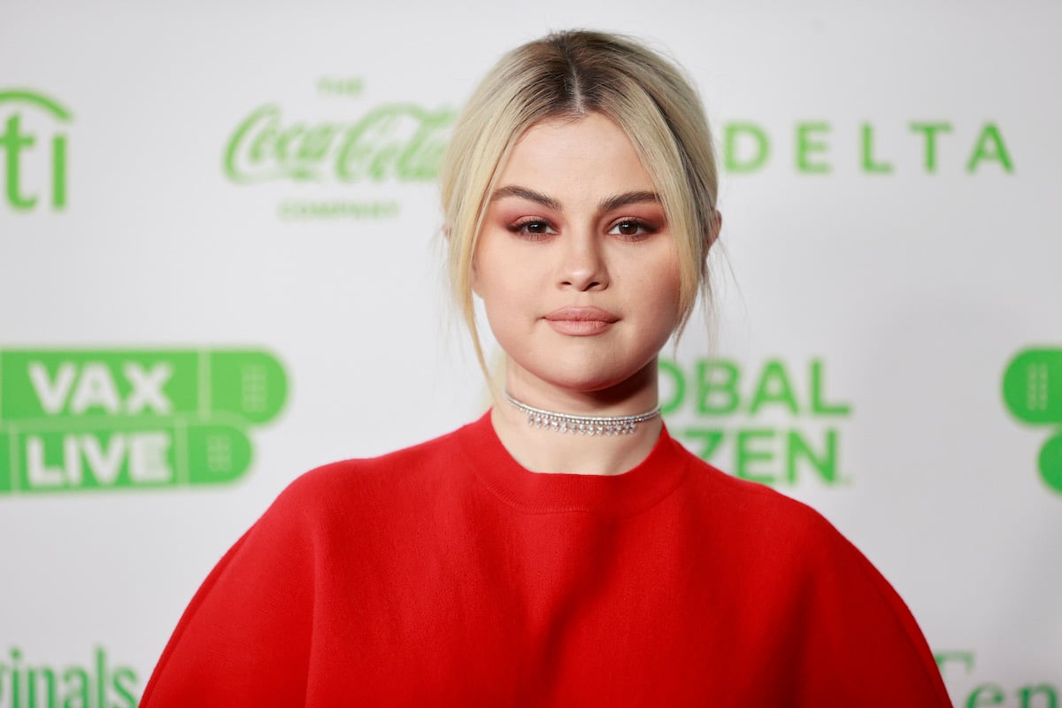 Selena Gomez smiling in front of a white background