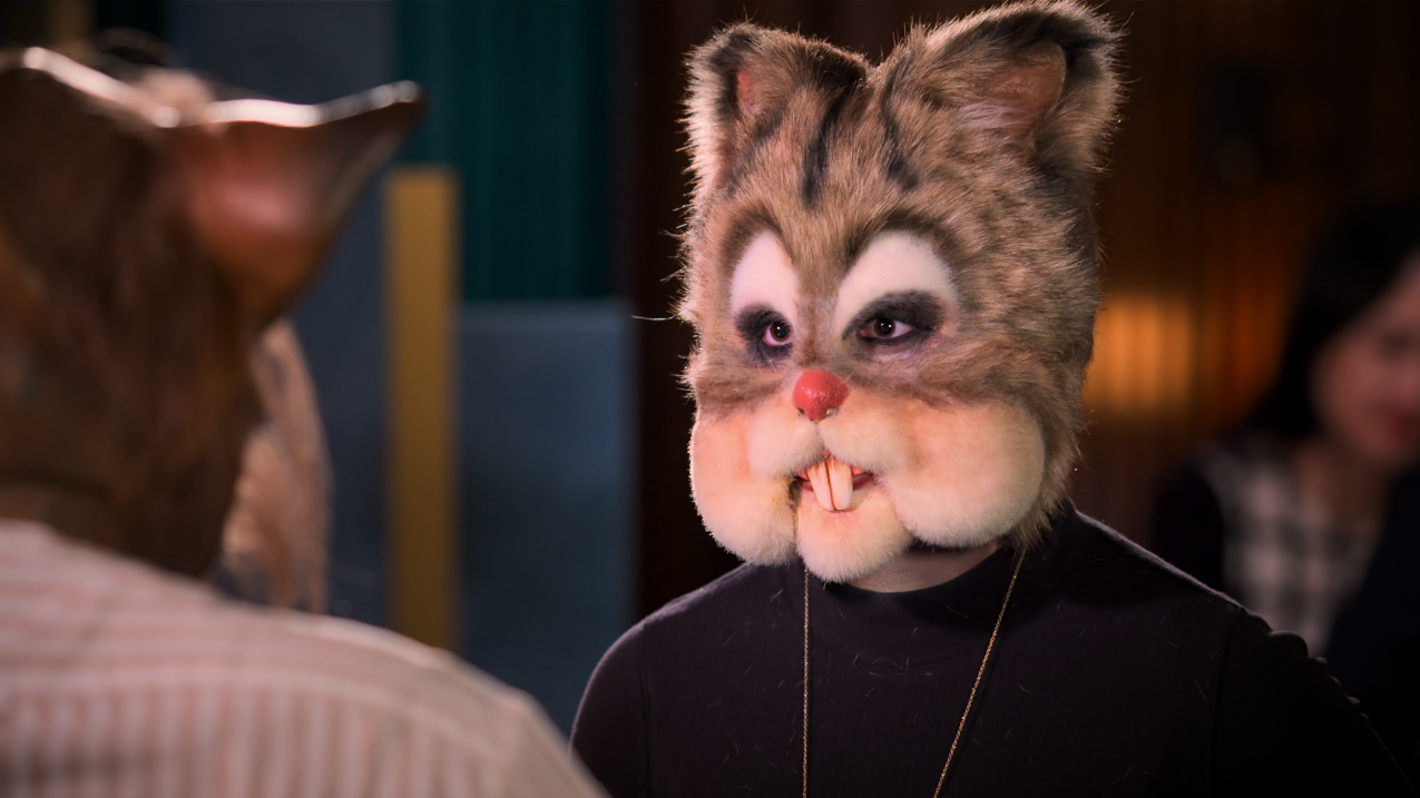 A person dressed as a chipmunk on 'Sexy Beast' sits at a table on a date.