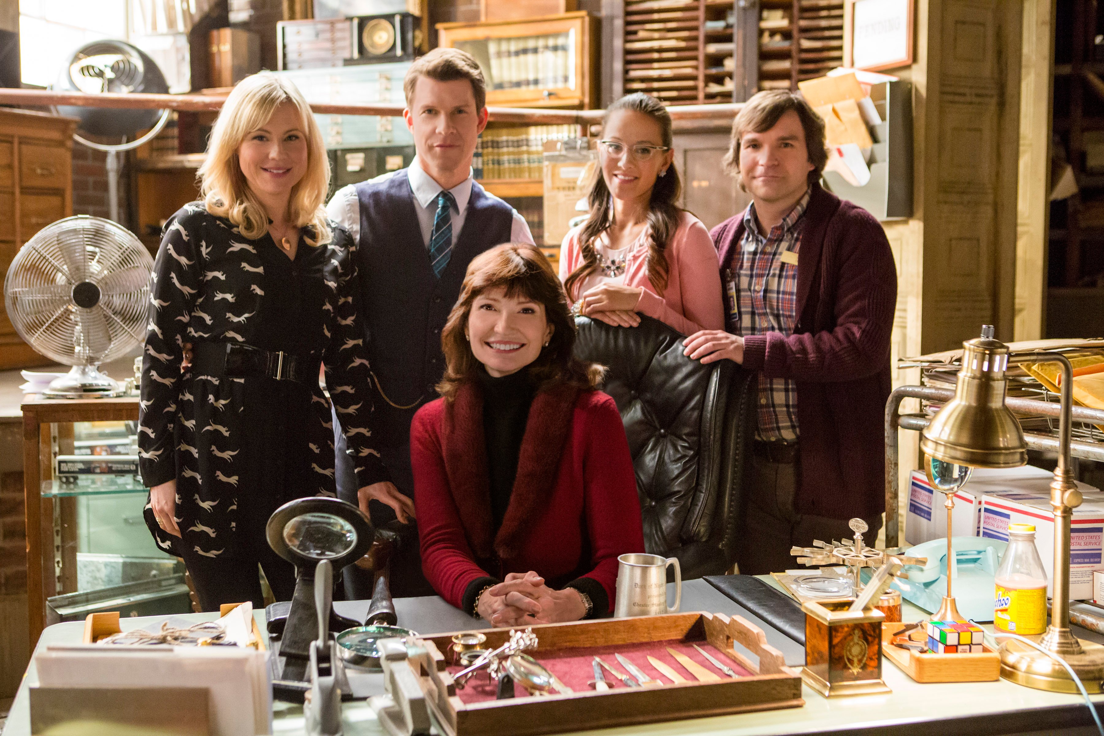 'Signed, Sealed, Delivered' Season 1 cast and creator Martha Williamson  behind a desk