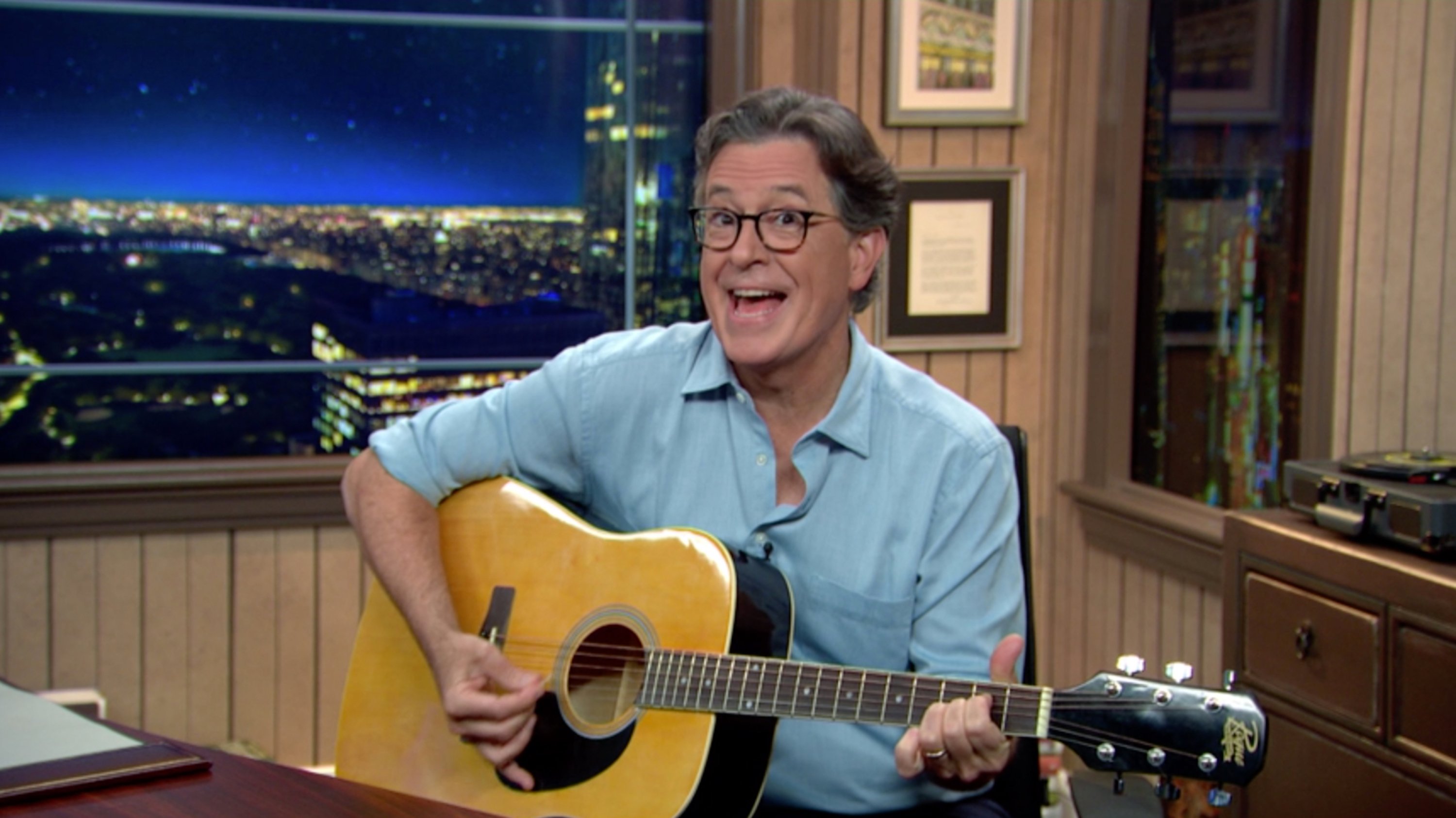 Stephen Colbert strums a guitar during a taping of his show, 'The Late Show with Stephen Colbert.'