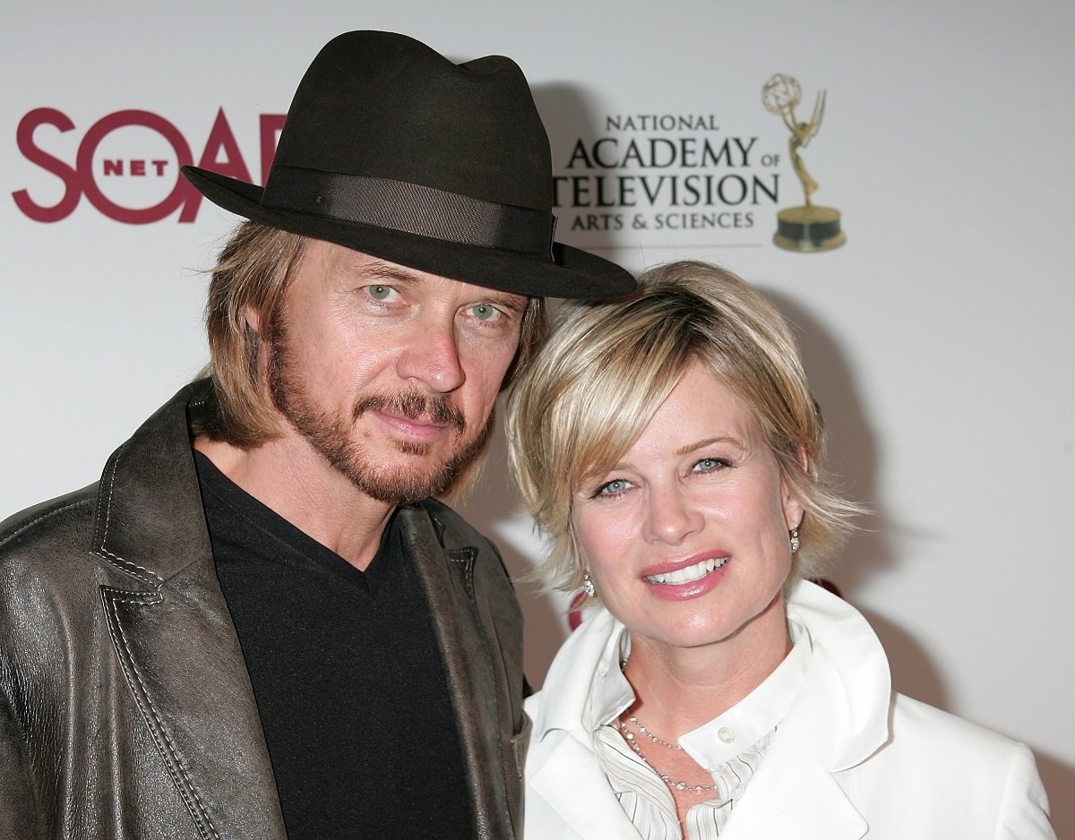'Days of Our Lives' actor Stephen Nichols in black shirt, jacket, and hat, and Mary Beth Evans in a white blouse pose on the red carpet at a SoapNet party.