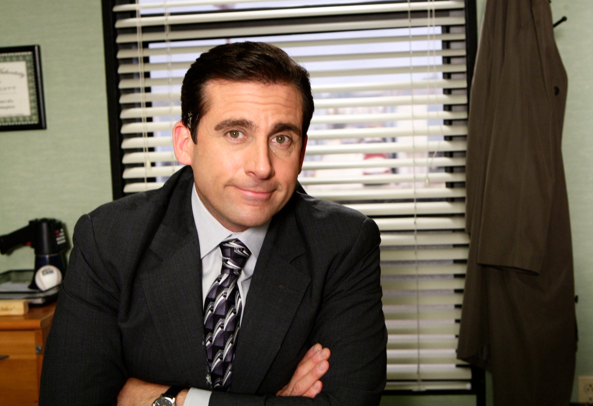 Steve Carell wearing a black suit in NBC's 'The Office.'