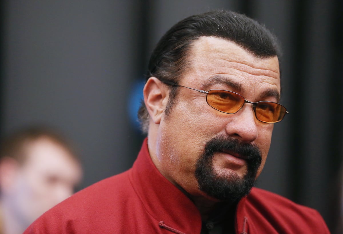 Steven Seagal wearing sunglasses and a red shirt