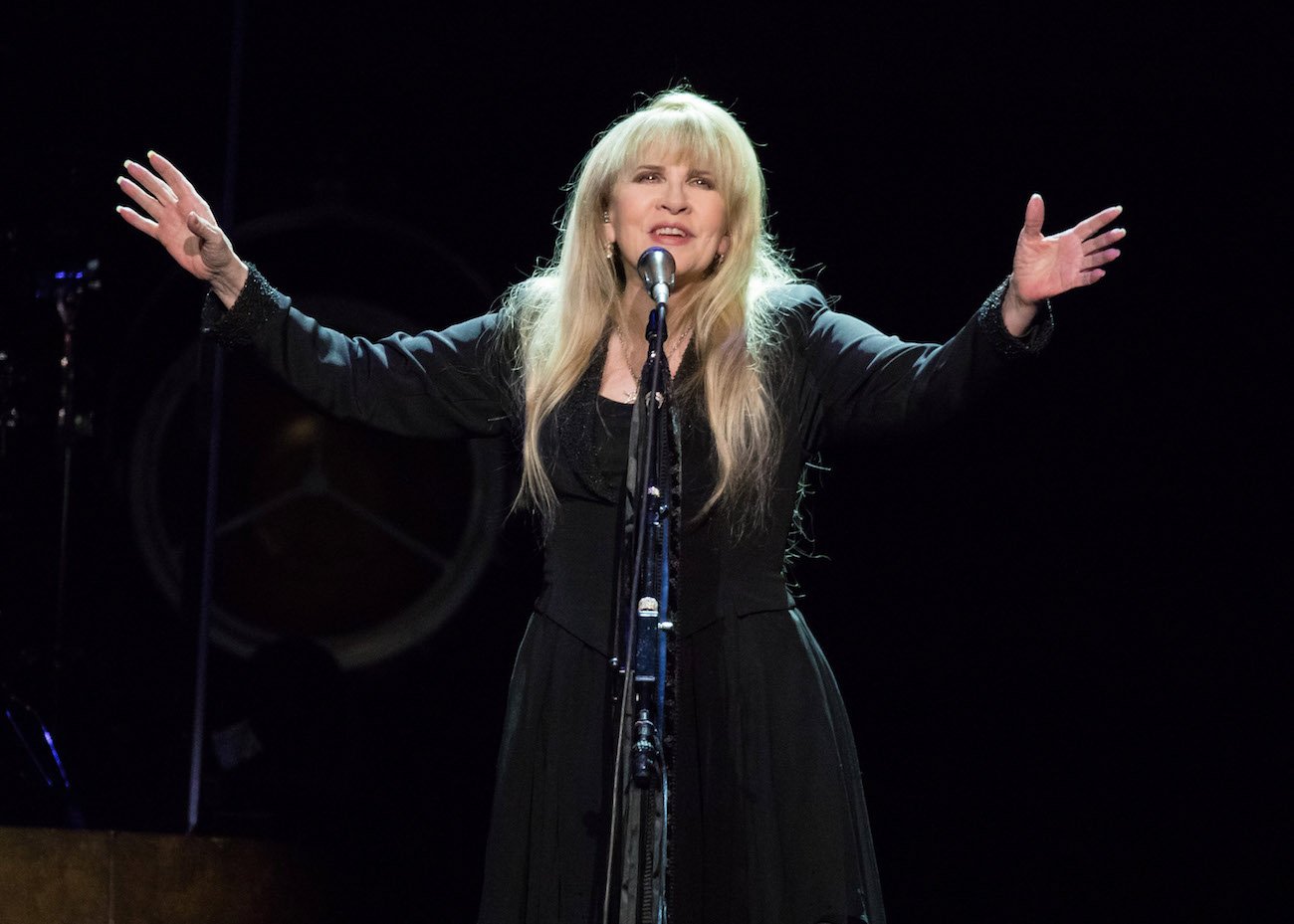 Stevie Nicks wearing black performing on stage in Michigan, 2016.