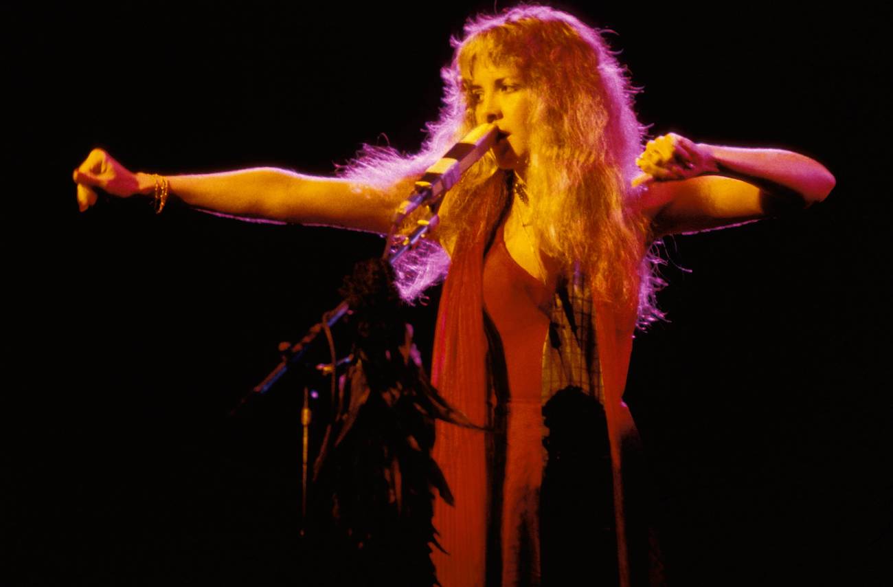 Stevie Nicks wearing red and performing on stage with Fleetwood Mac in 1978.