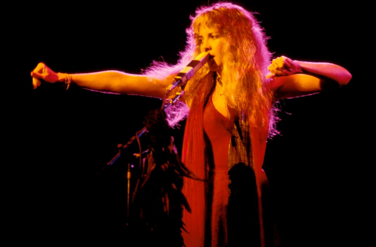 Stevie Nicks wearing red and performing on stage with Fleetwood Mac in 1978.