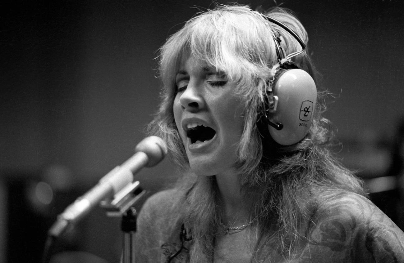 Stevie Nicks singing in the recording studio with Fleetwood Mac in 1975.