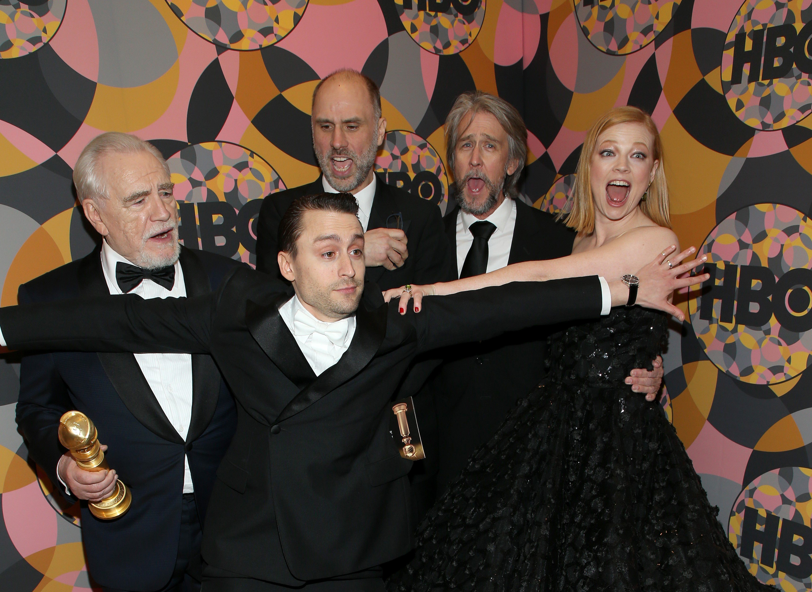 Jesse Armstrong and Succession cast members Brian Cox, Kieran Culkin, Jesse Armstrong, Alan Ruck, and Sarah Snook pose together in black outfits.