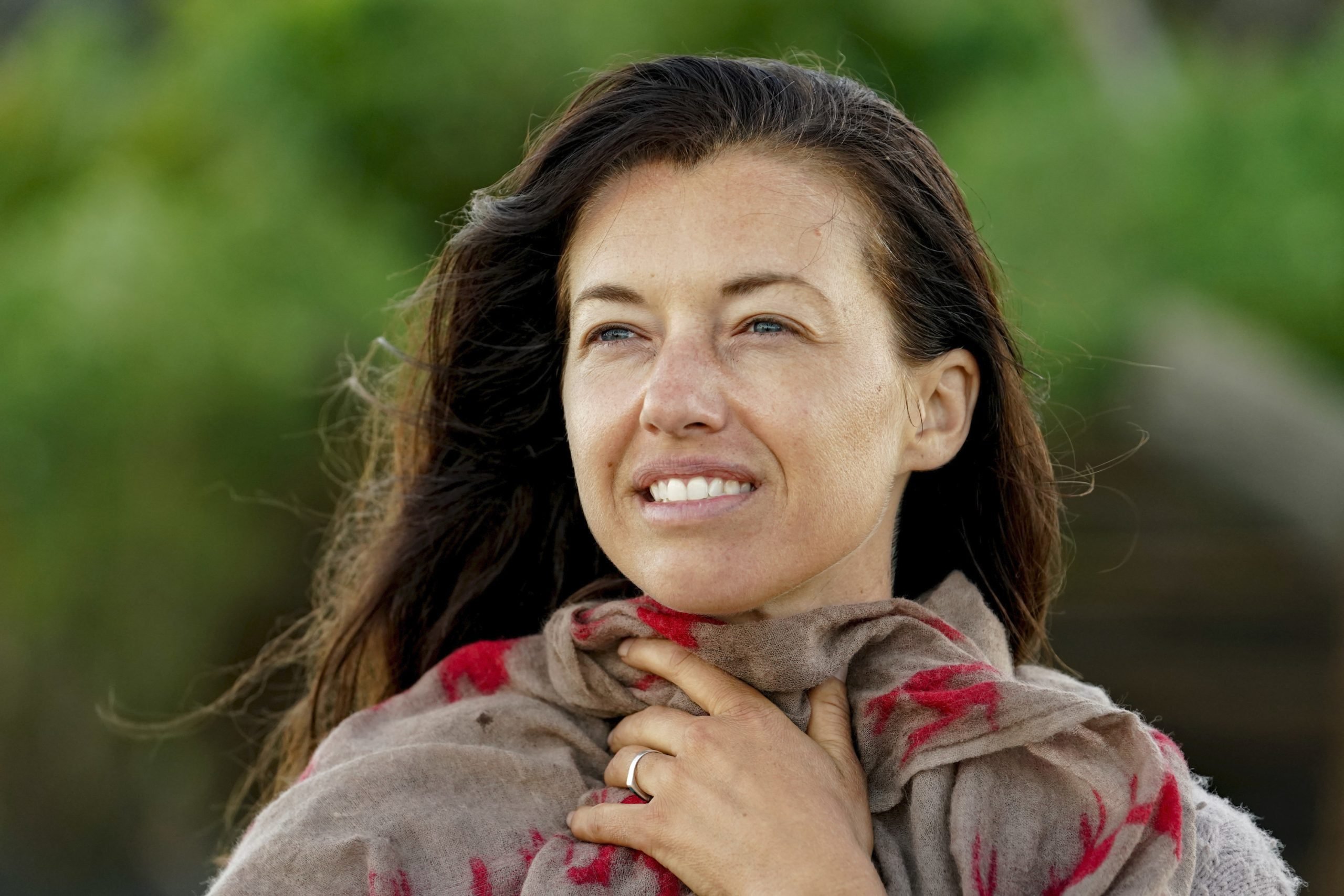 This is a closeup of Parvati Shallow's face as she hold a cloth around her neck on 'Survivor'