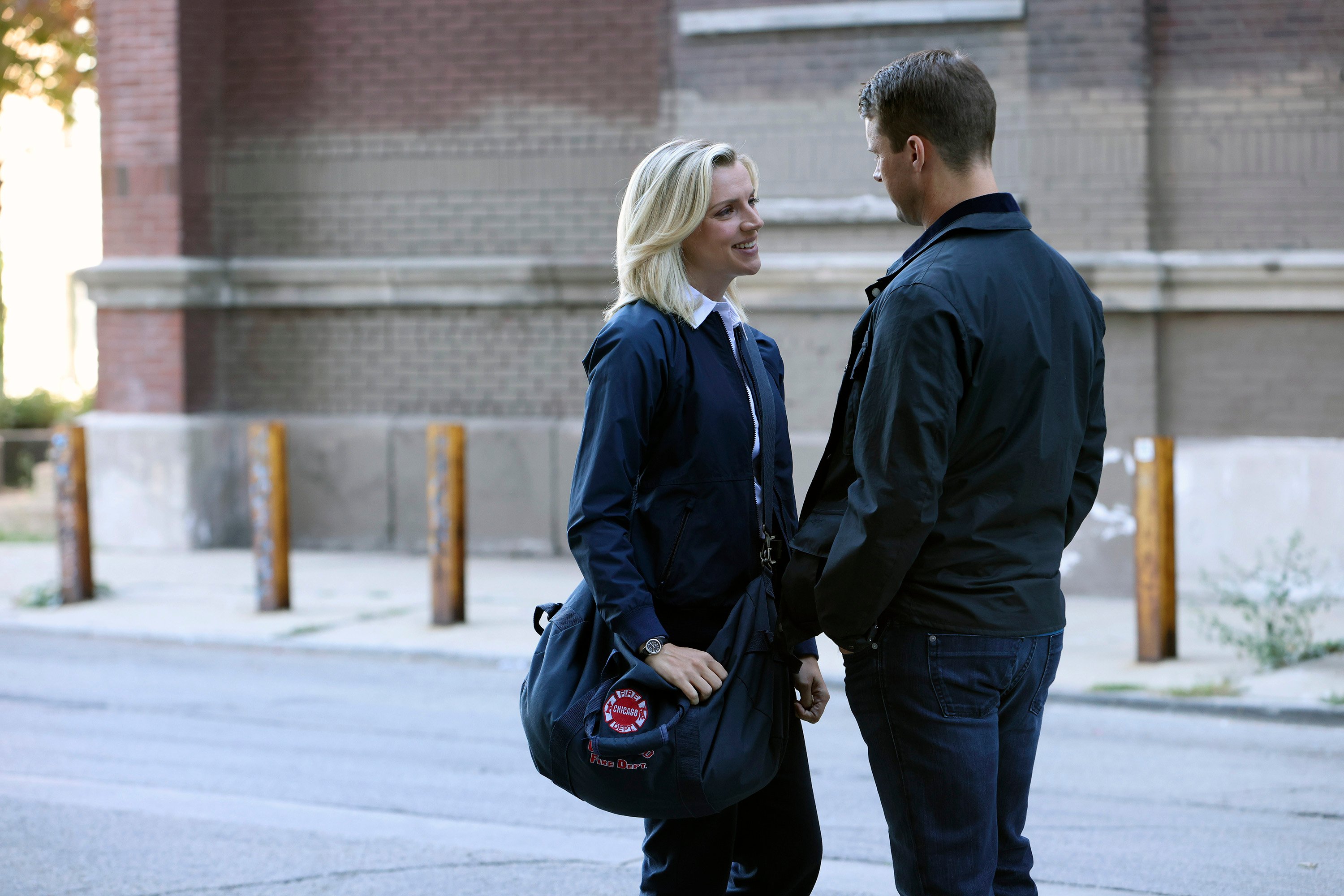 Sylvie Brett and Matt Casey standing on a street talking in 'Chicago Fire'