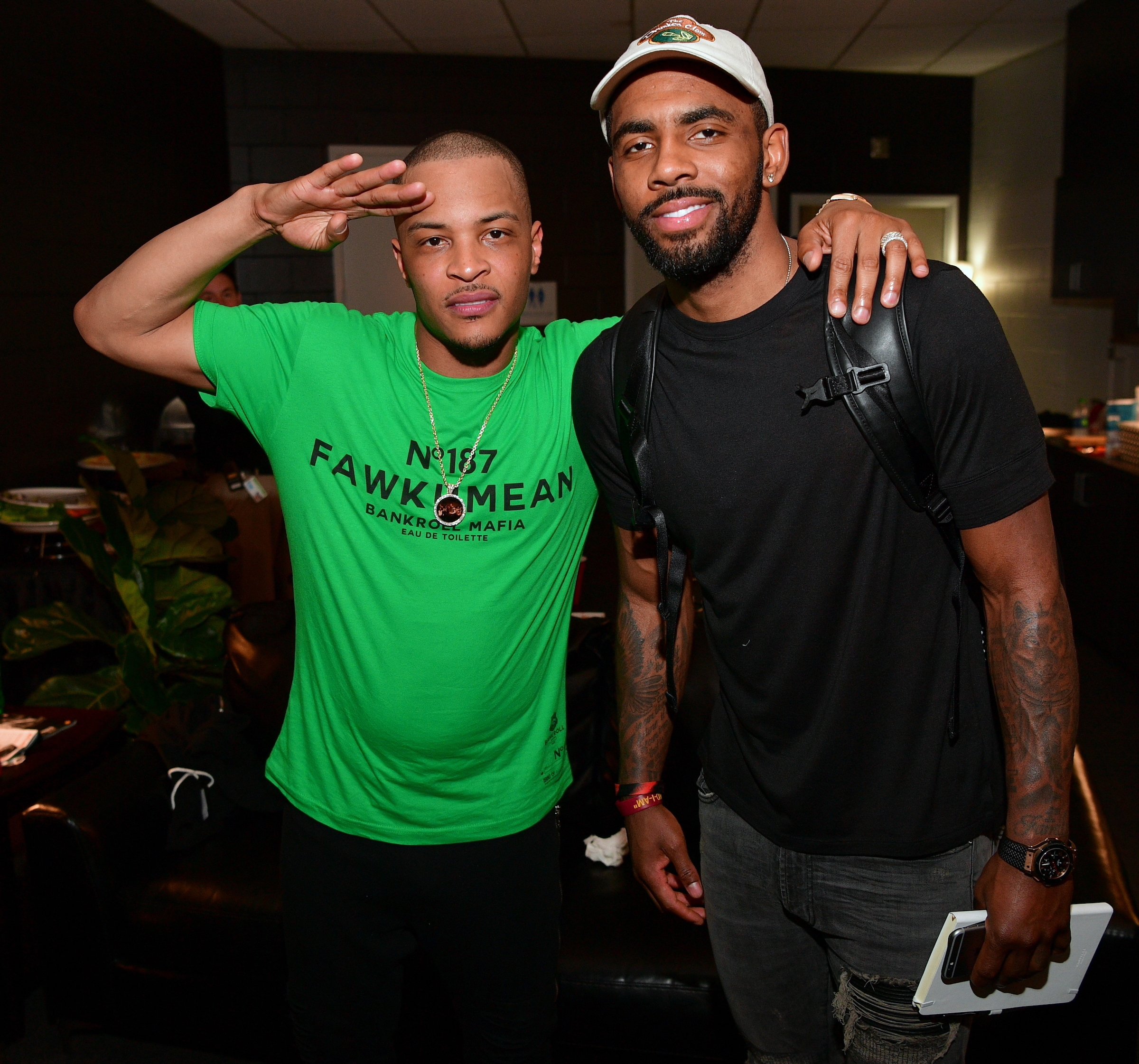 T.I. and Kyrie Irving smiling for a photo