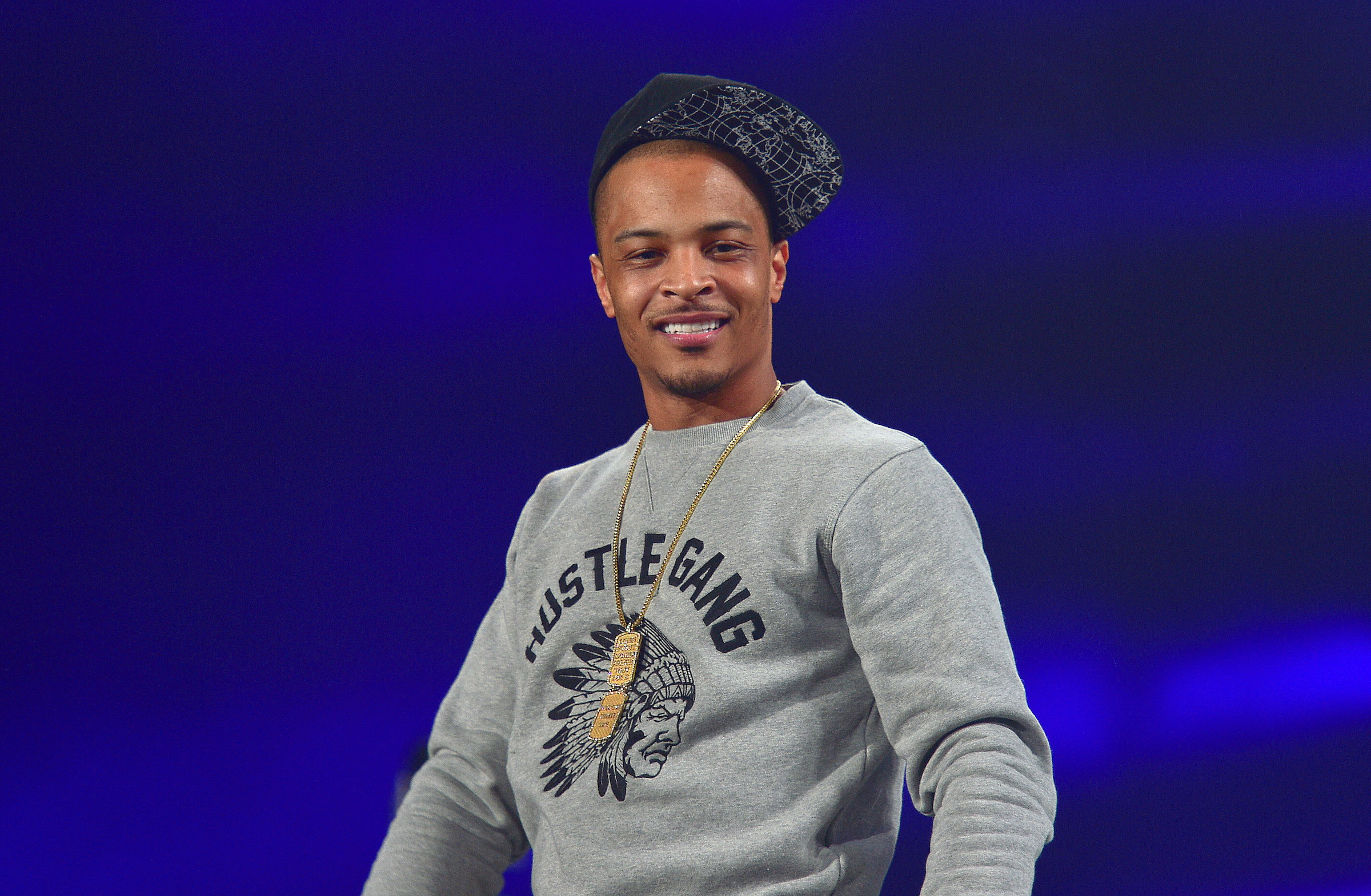 T.I. performing wearing a hat