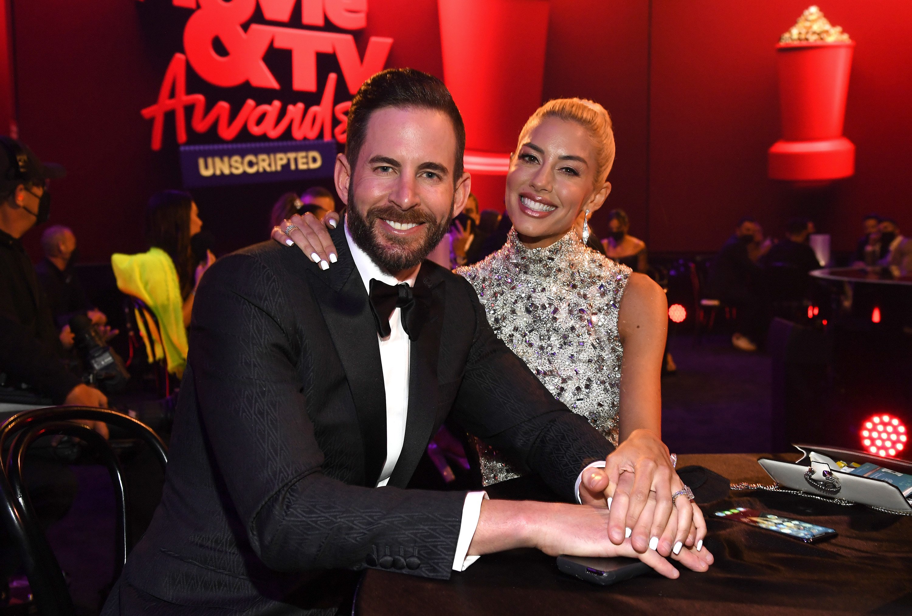 Tarek El Moussa and Heather Rae Young attend the 2021 MTV Movie & TV Awards: UNSCRIPTED in Los Angeles, California
