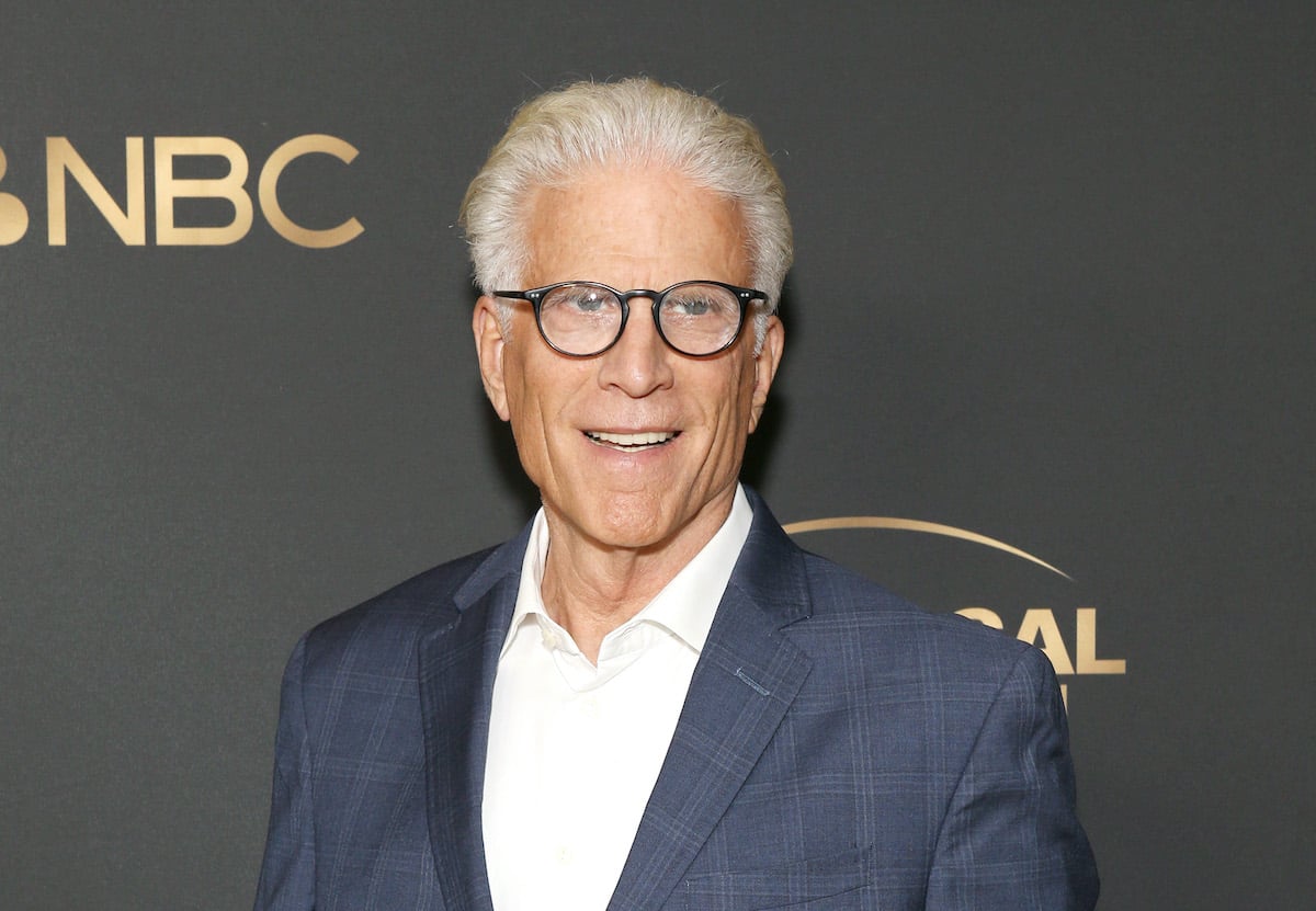 Ted Danson smiling in front of a black background