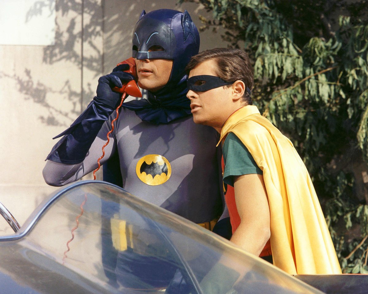 Adam West and Burt Ward as Batman and Robin, featured in 'Batman Wayne Family Adventures' and 'Teen Titans'