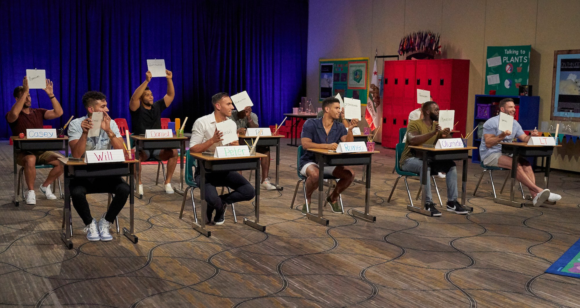 Some of the men from Michelle Young's season of 'The Bachelorette' sitting in a classroom for the first group date.