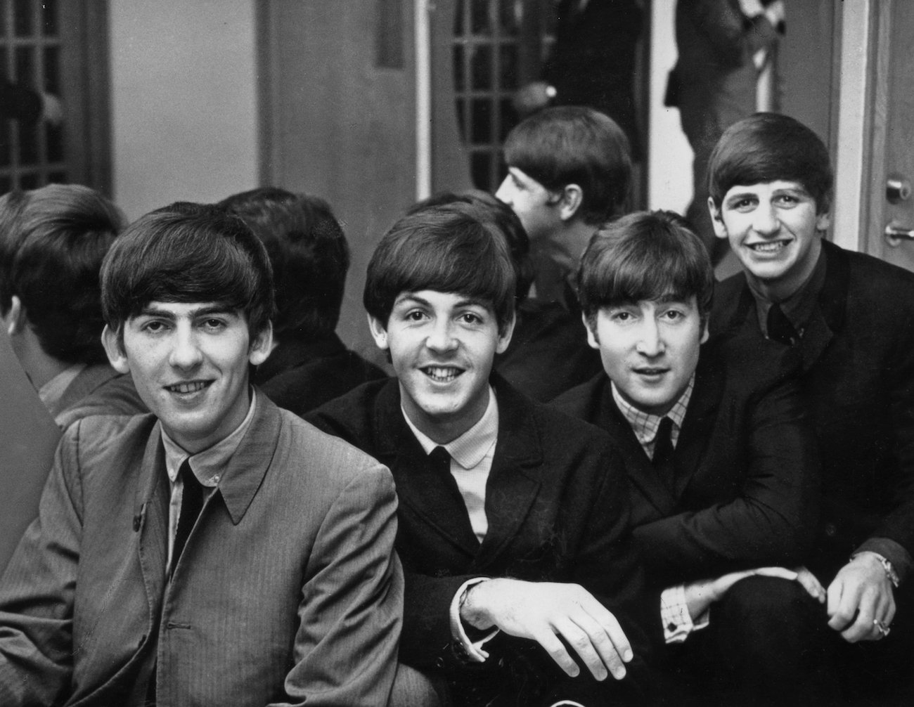The Beatles dressed in dark suits in Sweden, 1963.