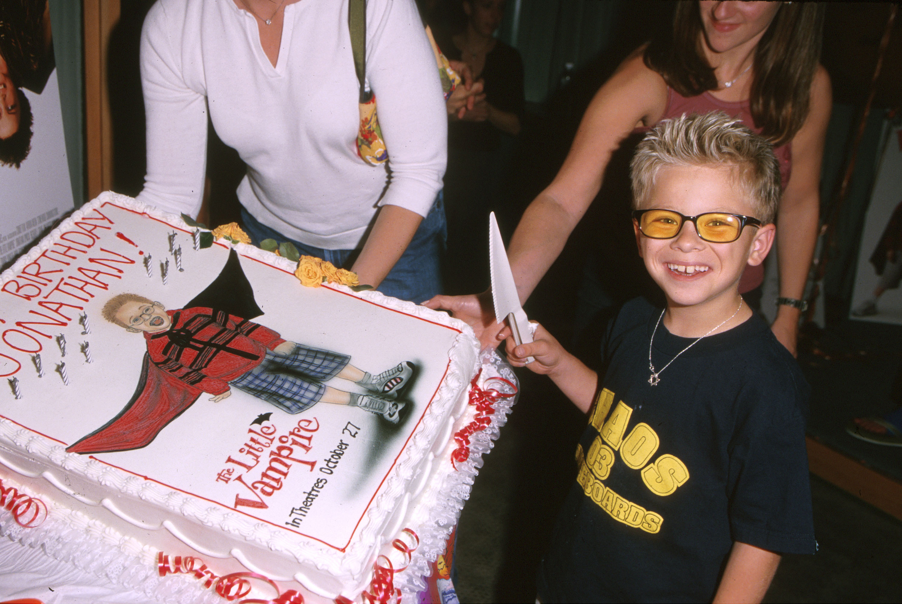 Jonathan Lipnicki cuts a birthday cake at the Little Vampire screening