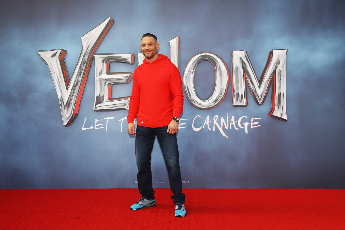 Tom Hardy posing with red sweater