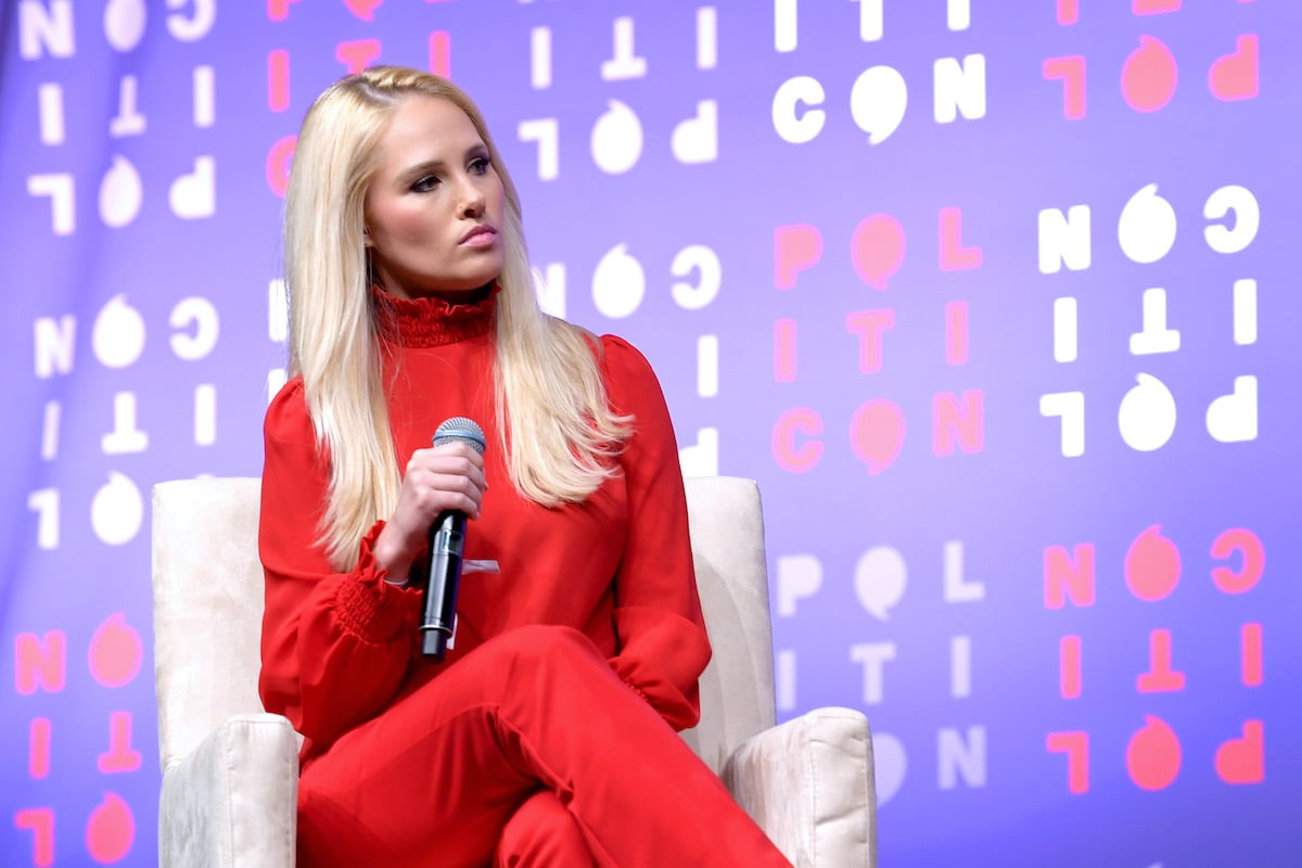Tomi Lahren sitting in front of a blue background