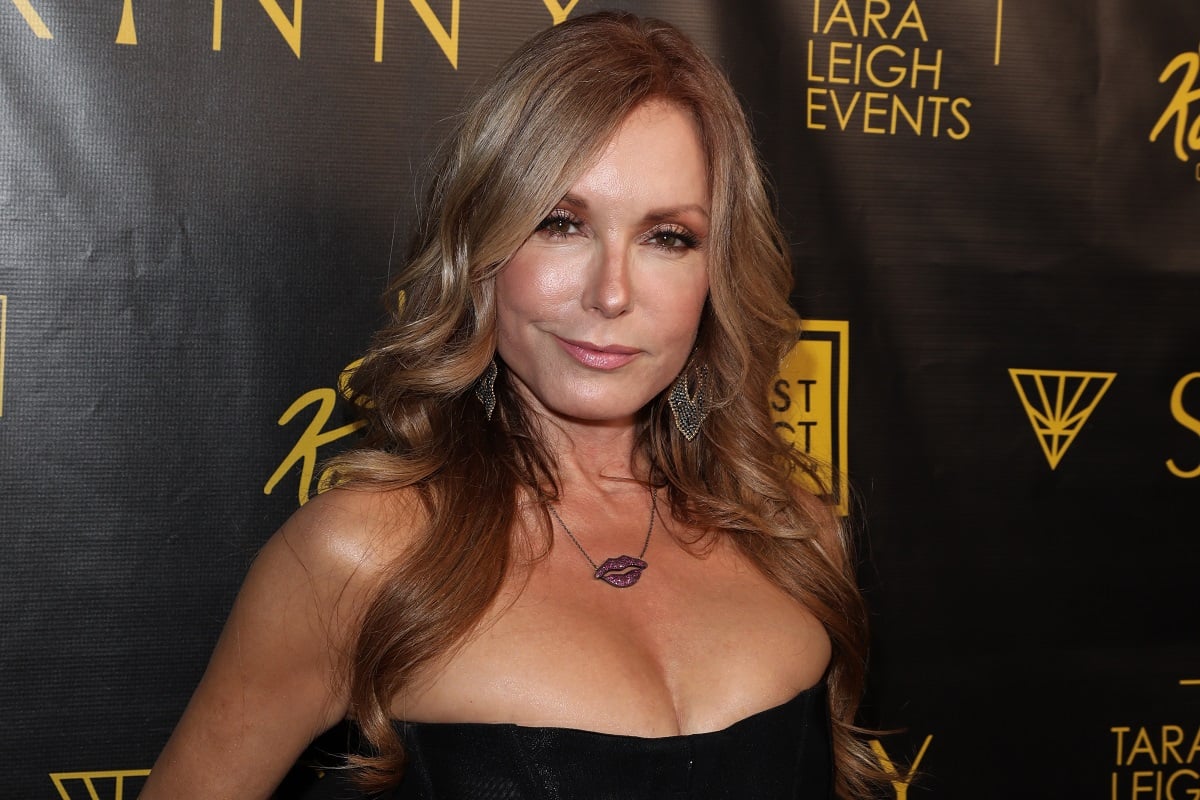 'The Young and the Restless' actor Tracey Bregman wearing a black dress and posing on the red carpet.