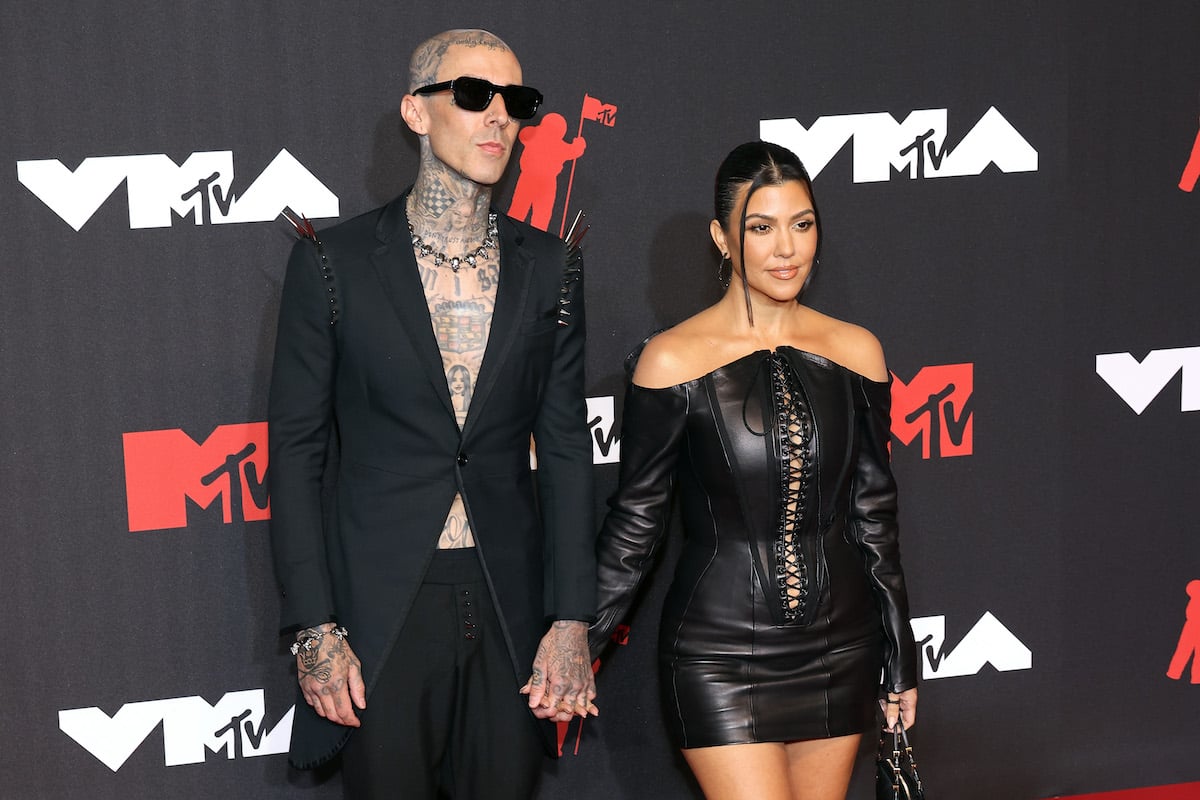 Travis Barker and Kourtney Kardashian pose together at the 2021 MTV VMAs.